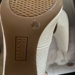 Alfani Jeules White snake heels size 5. Never worn. Heel is approximately 2 1/2.